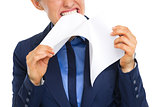 Closeup on displeased business woman tearing documents