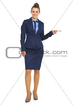 Full length portrait of business woman pointing on copy space wi
