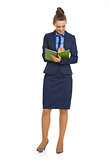 Full length portrait of business woman writing in notepad