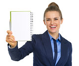 Smiling business woman showing open notepad