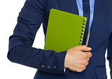 Closeup on business woman holding notepad