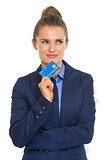 Portrait of thoughtful business woman with credit card