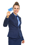 Smiling business woman showing credit card
