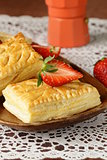dessert patties puff pastry with strawberries on wooden table