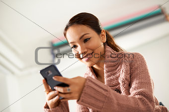 asian girl reading sms on smarthphone