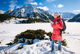 Young woman take a walk on winter mountain slope (Big Almaty Lak