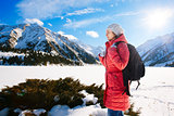 Young woman take a walk on winter mountain slope (Big Almaty Lak