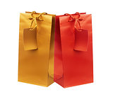 Golden and red gift shopping bags isolated on white