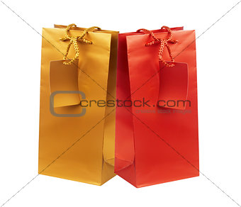 Golden and red gift shopping bags isolated on white
