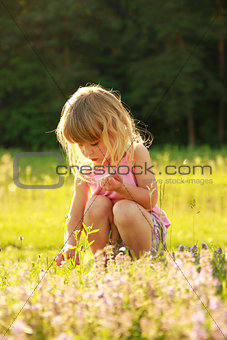 beautiful little girl playing in nature 