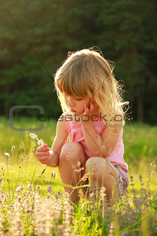 beautiful little girl playing in nature