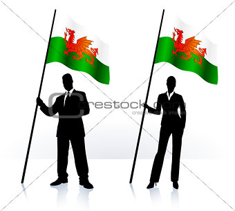 Business silhouettes with waving flag of Wales