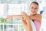 Sporty young woman stretching hands at yoga class