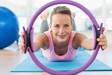 Sporty woman with exercise ring in fitness studio