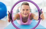 Sporty woman with exercise ring in fitness studio