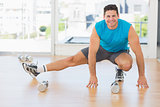 Portrait of a sporty man doing stretching exercise