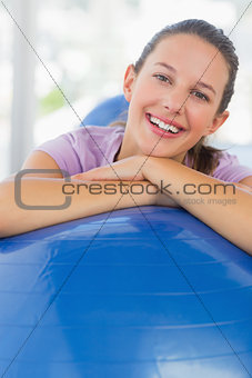 Portrait of a smiling fit woman with exercise ball