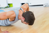 Determined man doing push ups in gym