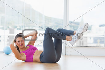 Young woman doing pilate exercises in fitness studio