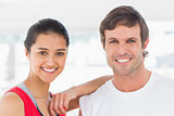 Closeup of a fit smiling couple in exercise room