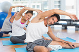 Sporty people stretching hands at yoga class
