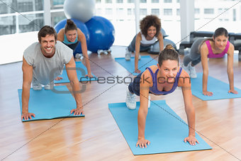 People doing push ups in fitness studio