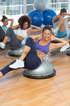 Portrait of cheerful fitness class doing pilates exercise