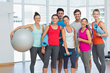 Fit people smiling in a bright exercise room
