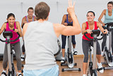 Trainer and fitness class at spinning class