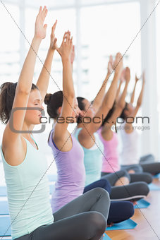 Sporty young women in meditation pose with eyes closed