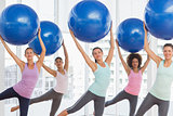 Fitness class doing pilates exercise with fitness balls