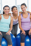 Fit young women smiling in exercise room