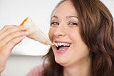 Closeup of a beautiful woman eating sandwich