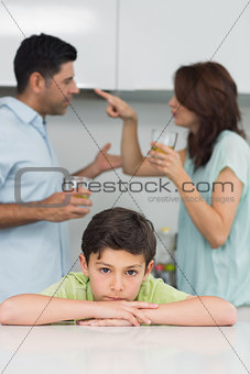 Portrait of a sad son while parents quarreling