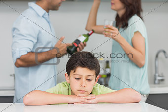 Closeup of a sad son while parents quarreling