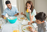 Family of three sitting at dining table