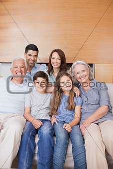 Extended family sitting on sofa in the living room