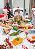 Cheerful family at dining table for christmas dinner
