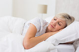 Woman sleeping with eyes closed in bed