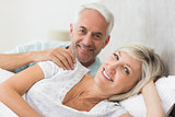Closeup of a smiling mature couple lying in bed
