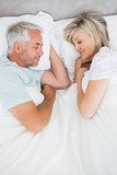 Mature couple lying in bed