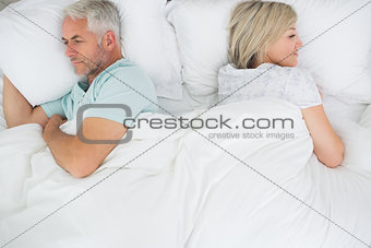 Mature couple lying in bed