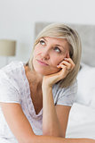 Tensed mature woman sitting in bed