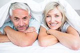 Closeup of a mature couple lying in bed