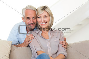 Portrait of a smiling couple sitting on sofa