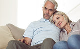 Relaxed couple sitting on sofa