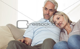 Relaxed couple sitting on sofa