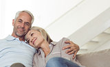 Relaxed mature couple sitting on sofa
