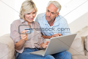 Mature couple doing online shopping at home