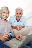 Mature couple doing online shopping at home
